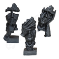 Set of three decorative sculptures of faces on a white background