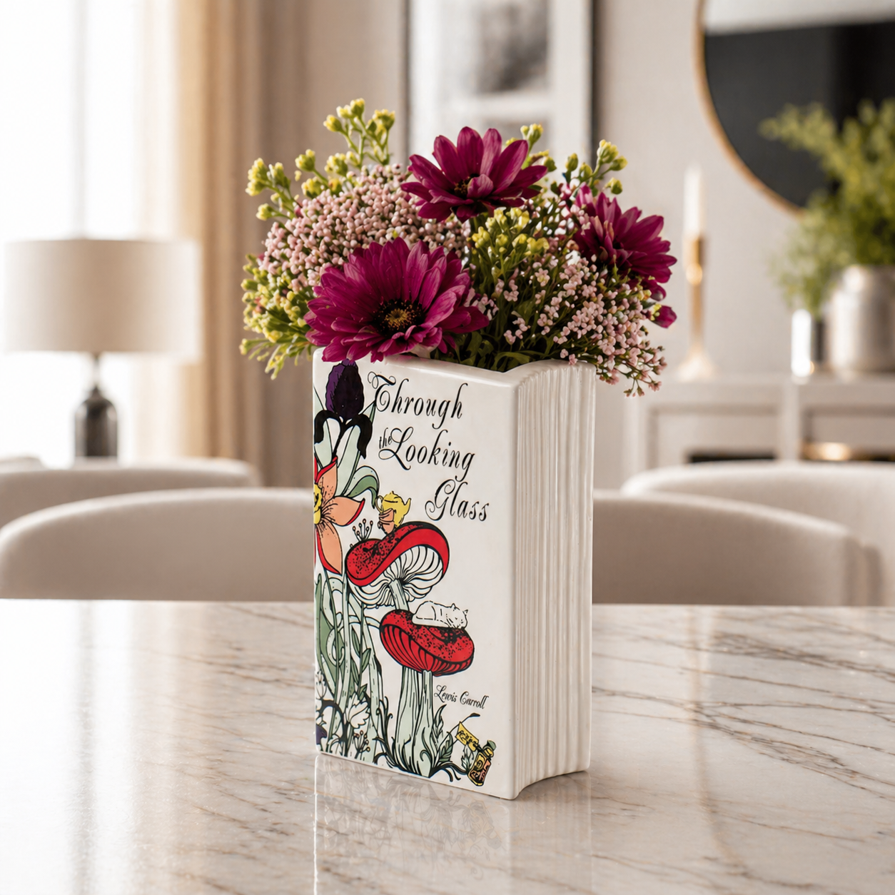 Book titled 'Through the Looking Glass' with floral design on a marble surface