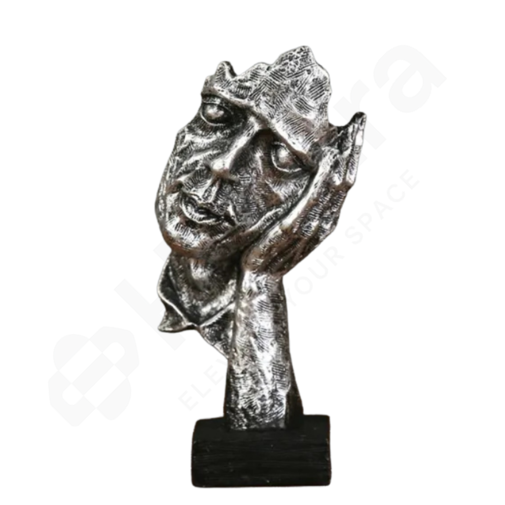 Silver statue of a face with a crown on a white background