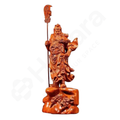 Wooden sculpture of a warrior figure holding a spear on a white background