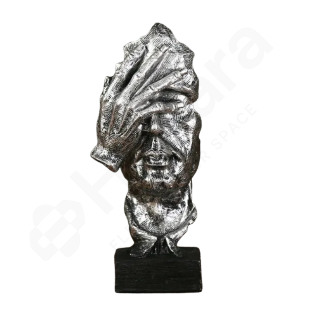 Metallic sculpture of a head with a turban on a white background